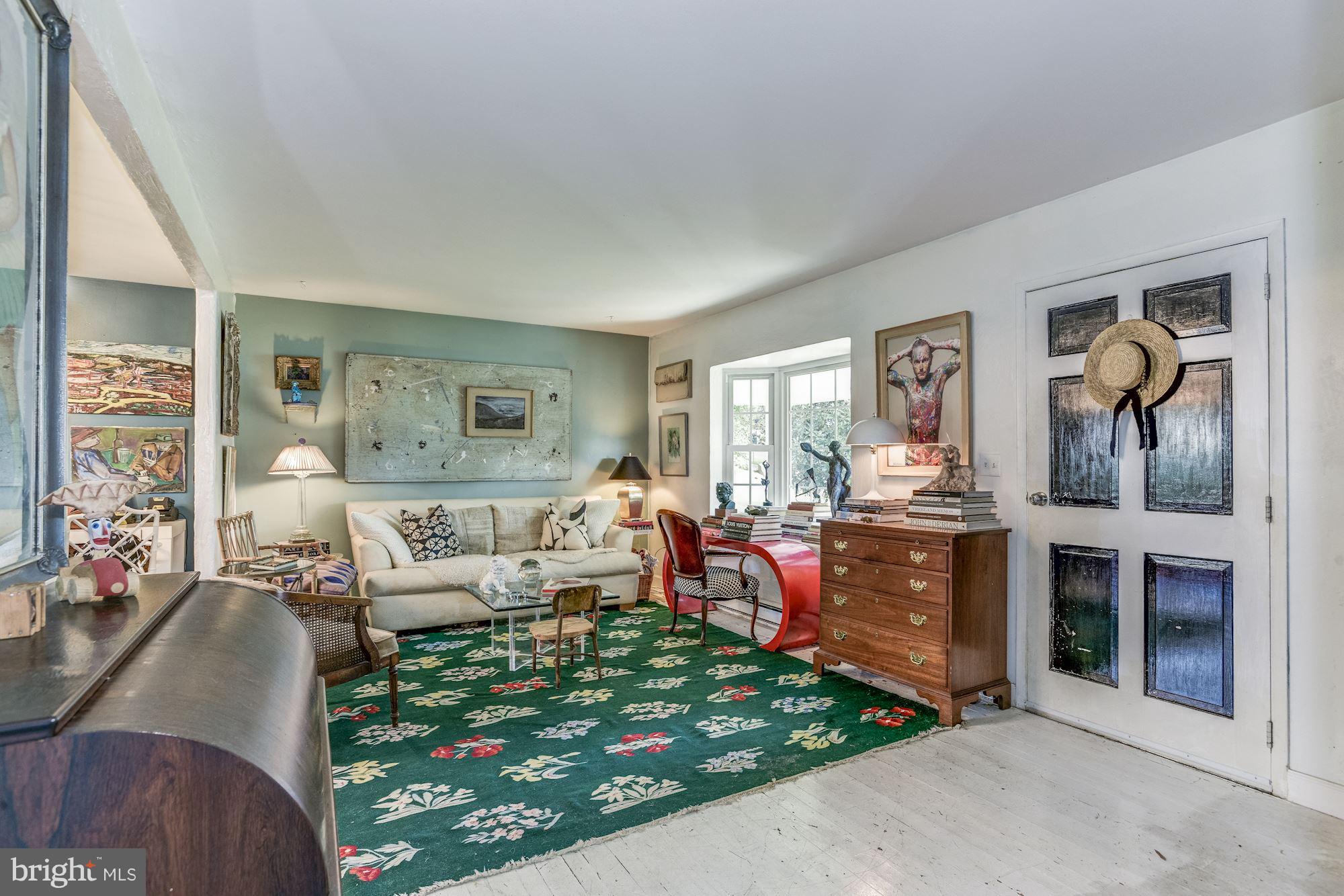 800 Blue Ridge Avenue Middleburg, VA 20117 - Photo 5 of 19 a living room with furniture a fireplace and a large window