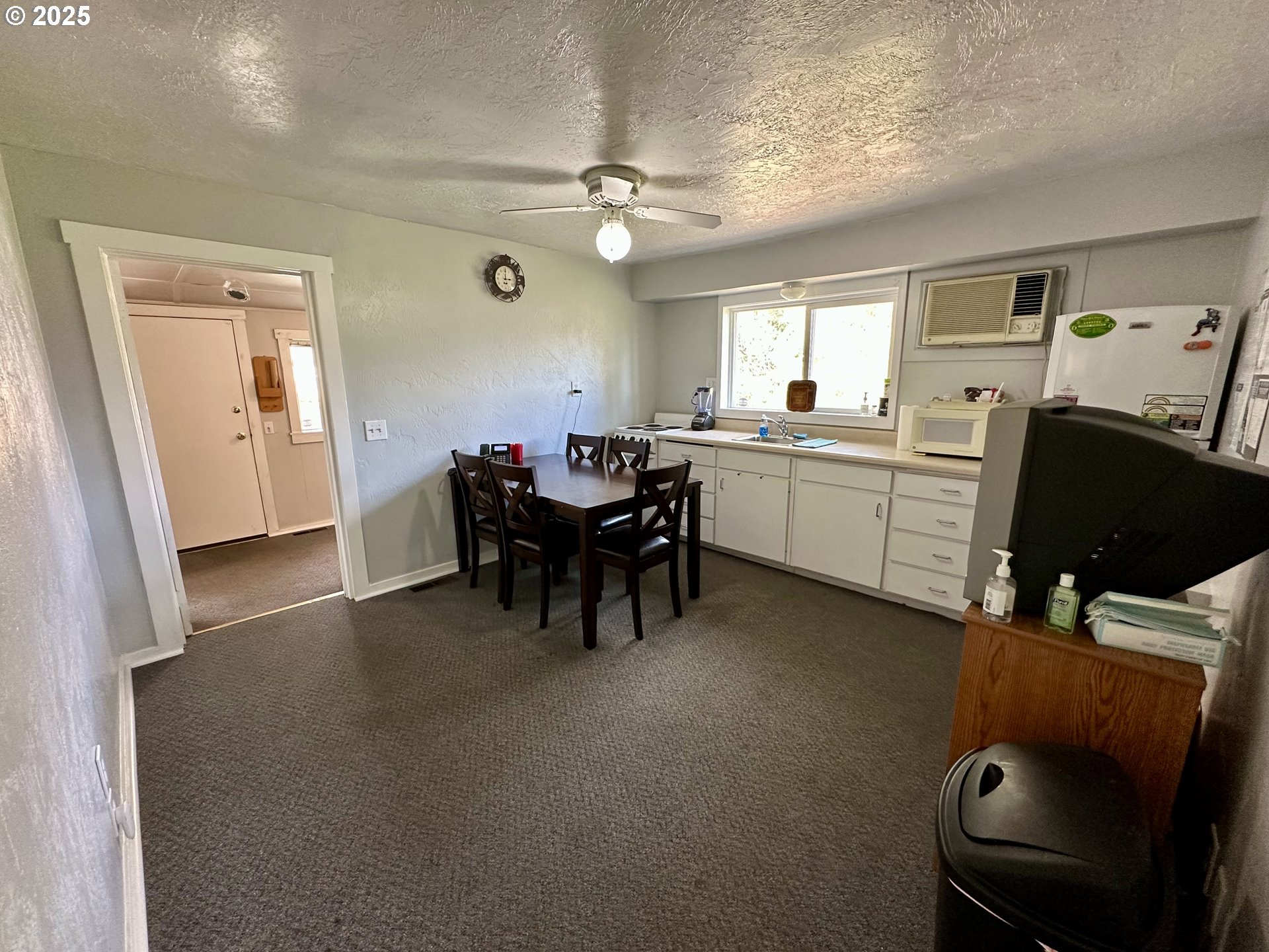 83 Swain Lane Eugene, OR 97404 - Photo 8 of 23 a living room with furniture a dining table and a fireplace