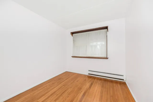 a view of a kitchen with a sink and a refrigerator
