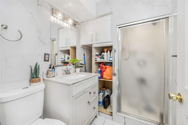 a bathroom with a sink mirror vanity and toilet