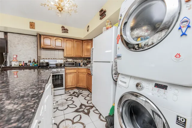a kitchen with stainless steel appliances granite countertop a sink and a stove