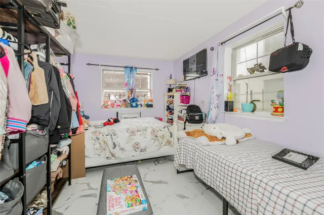 a bedroom with furniture and a baby crib