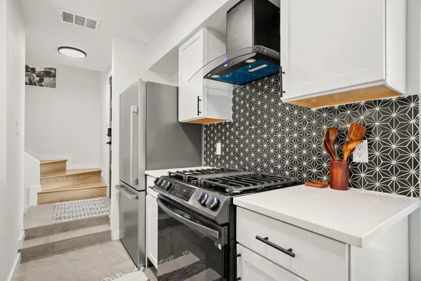 a kitchen with stainless steel appliances a stove and a refrigerator