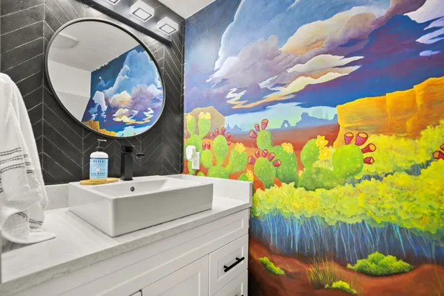 a bathroom with a sink mirror and vanity