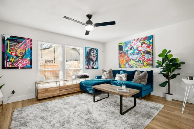 a living room with furniture a rug and a window