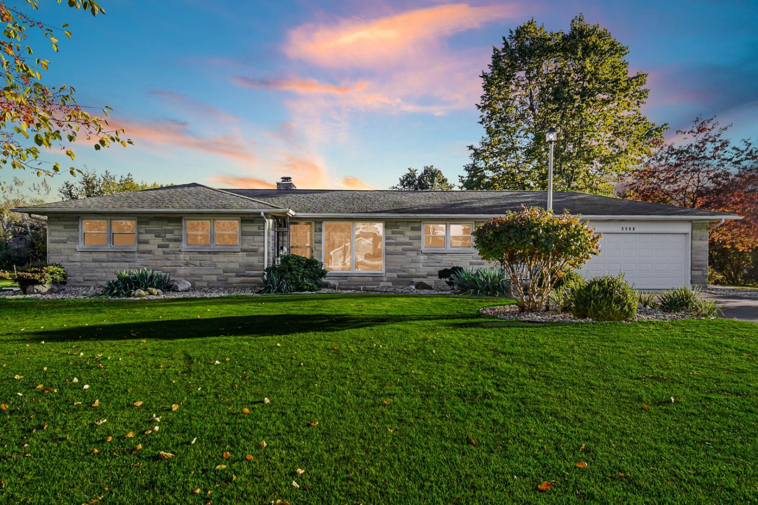 3508 Highway 20 Rolling Prairie, IN 46371 - Photo 1 of 29 a front view of a house with a yard and potted plants