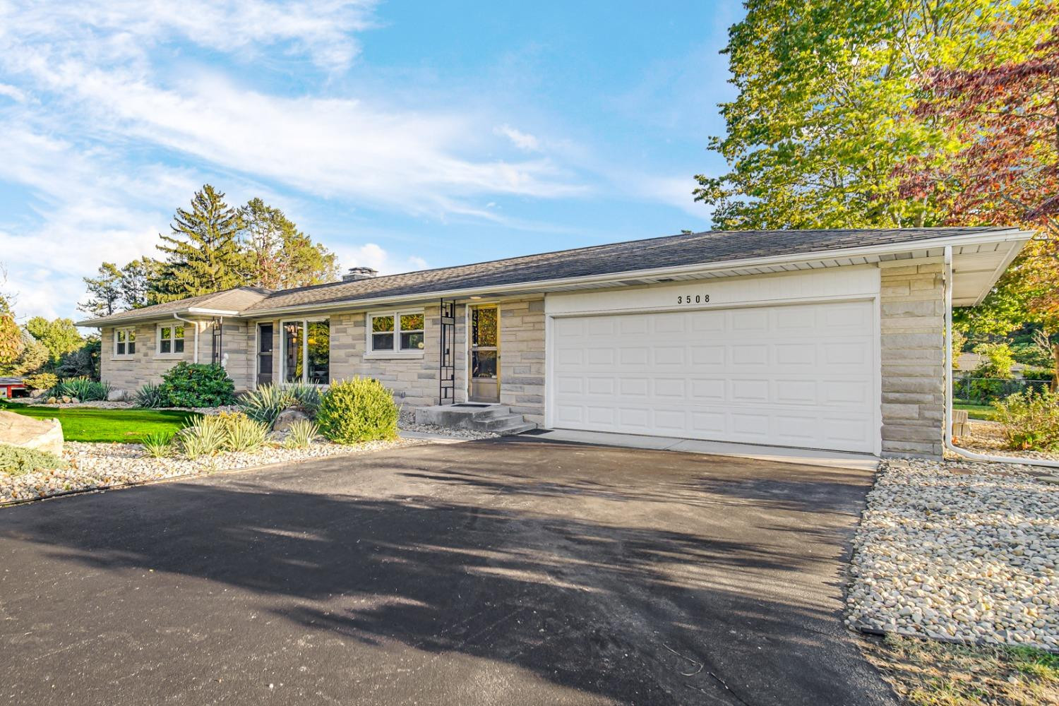 3508 Highway 20 Rolling Prairie, IN 46371 - Photo 4 of 29 a front view of a house with a yard and potted plants