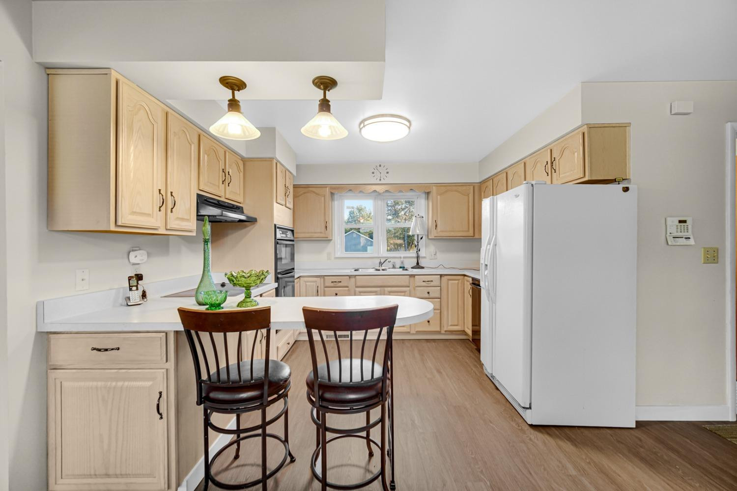 3508 Highway 20 Rolling Prairie, IN 46371 - Photo 8 of 29 a kitchen with stainless steel appliances granite countertop a dining table chairs refrigerator and sink