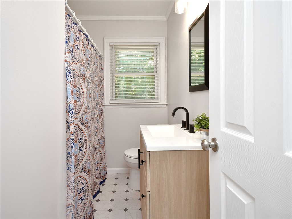 3517 Shawnee Avenue Anderson, SC 29626 - Photo 10 of 25 A well-appointed bathroom features a contemporary vanity and stylish patterned shower curtain.