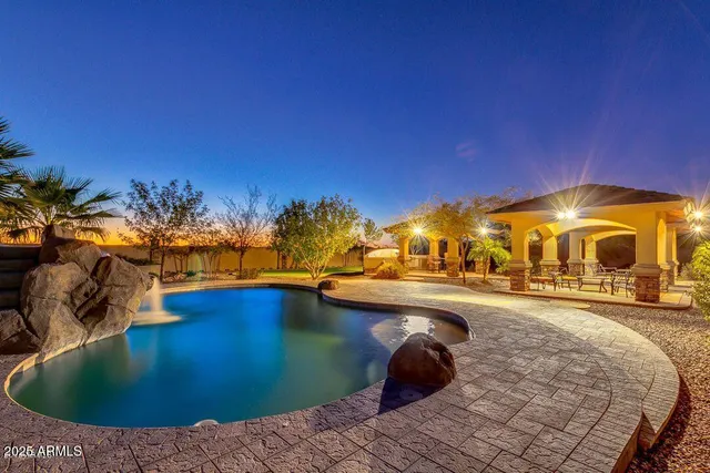a view of a swimming pool with an outdoor space and seating area