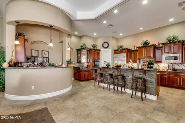 a living room with lots of furniture and kitchen view