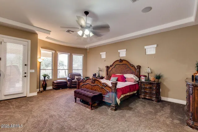 a spacious bedroom with a bed and a couch