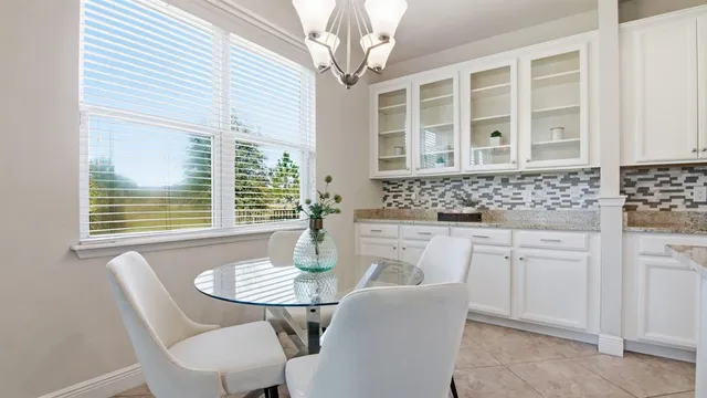 a view of a dining room with furniture and window