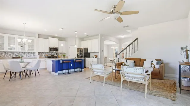 a living room with lots of furniture and kitchen view