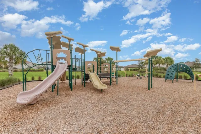 a view of a field with large trees