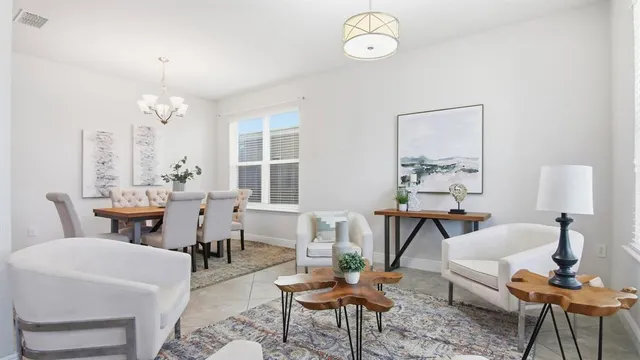 a living room with furniture a table and a large mirror