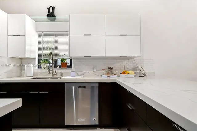 a kitchen with stainless steel appliances a sink stove and refrigerator