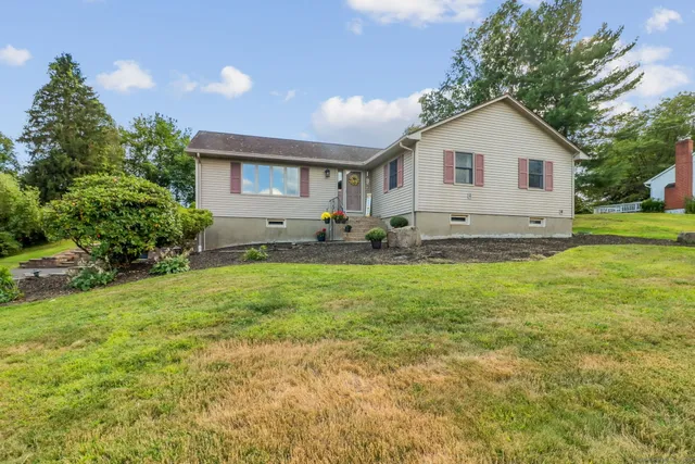 a front view of a house with garden