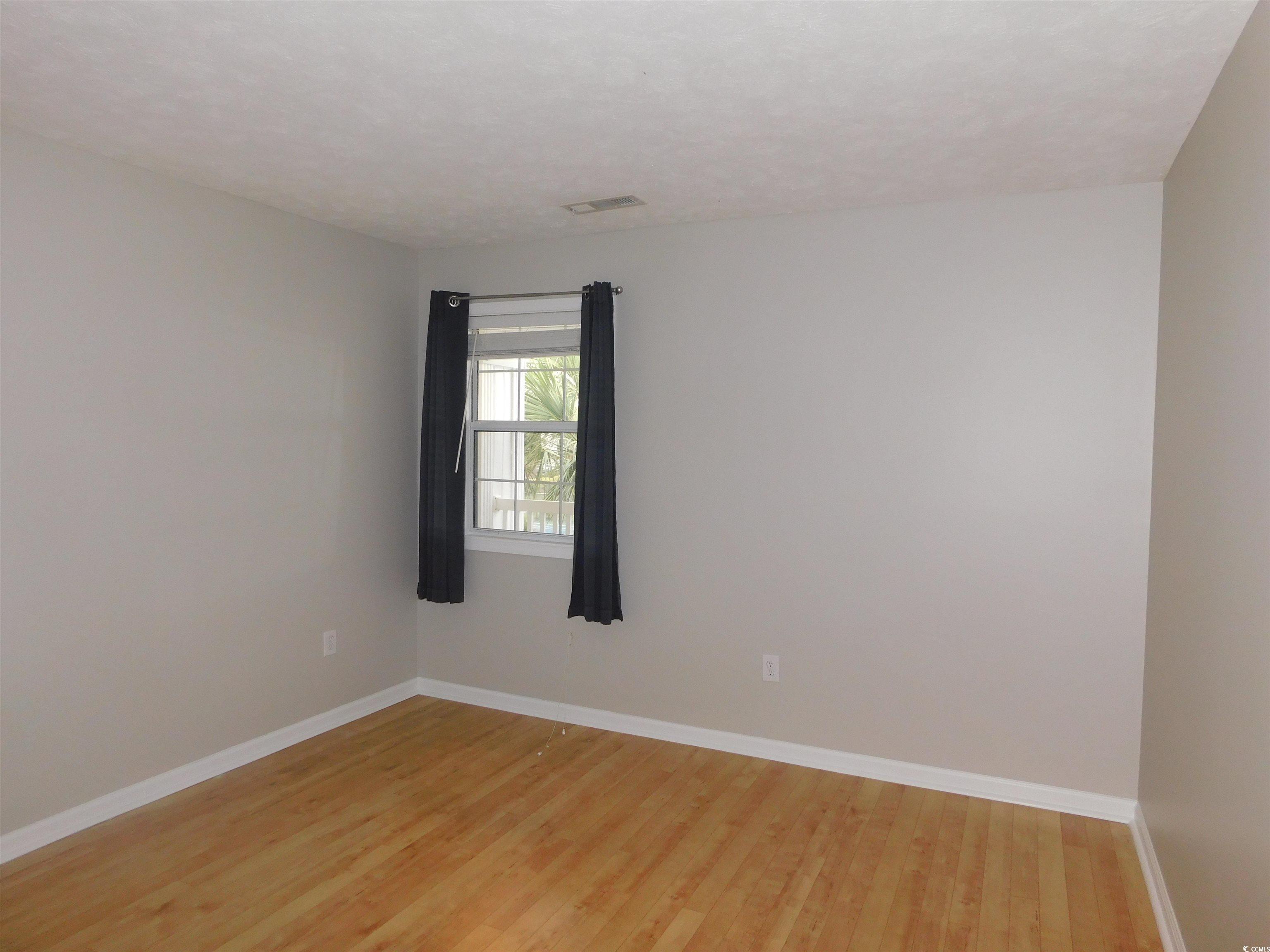 517 White River Drive, Unit BUILDING 22 G Myrtle Beach, SC 29579 - Photo 15 of 17 Kitchen featuring a peninsula, light wood-style floors, light stone countertops, white cabinetry, and lofted ceiling