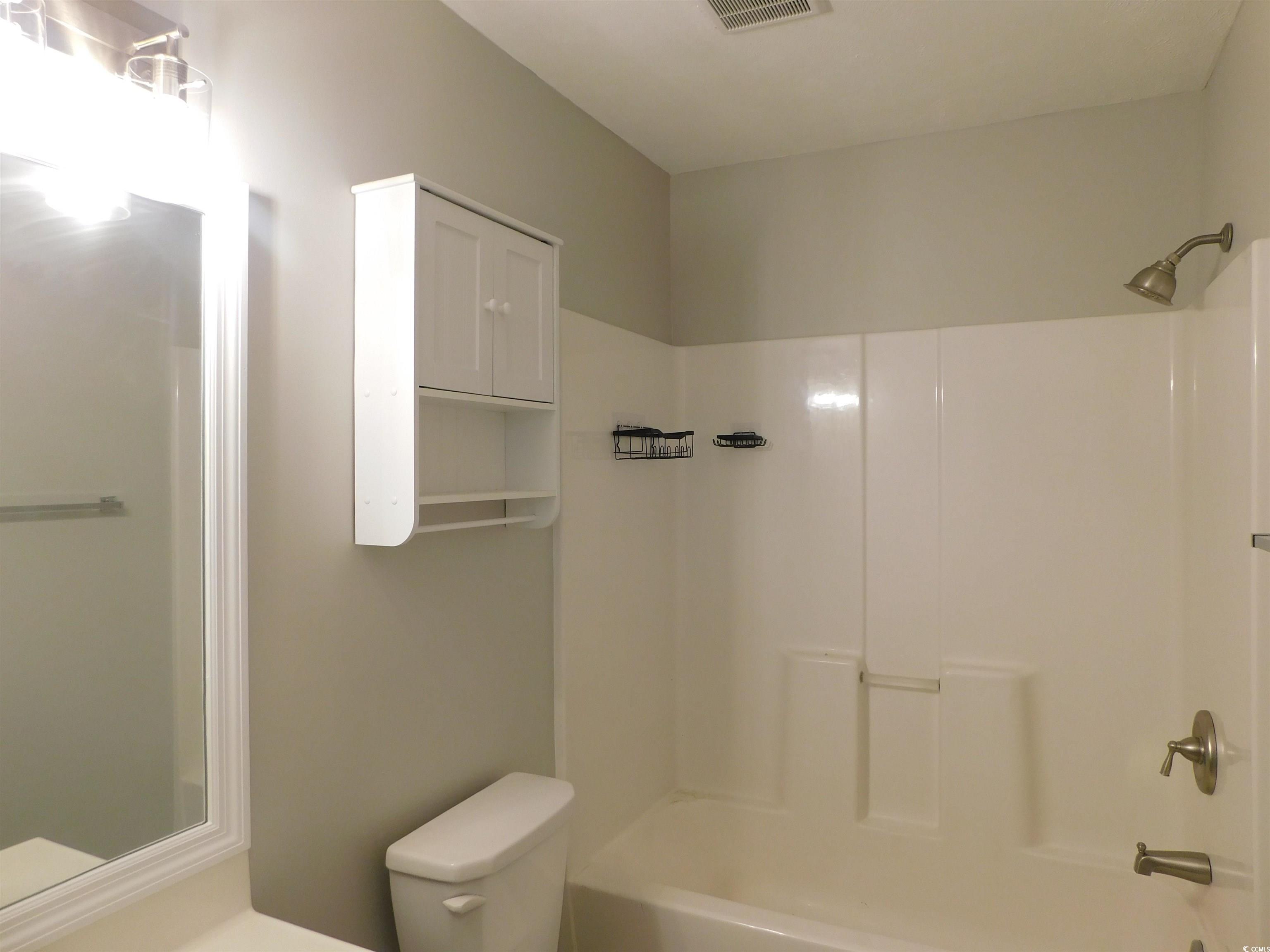 517 White River Drive, Unit BUILDING 22 G Myrtle Beach, SC 29579 - Photo 16 of 17 Empty room with light wood-style flooring and a textured ceiling