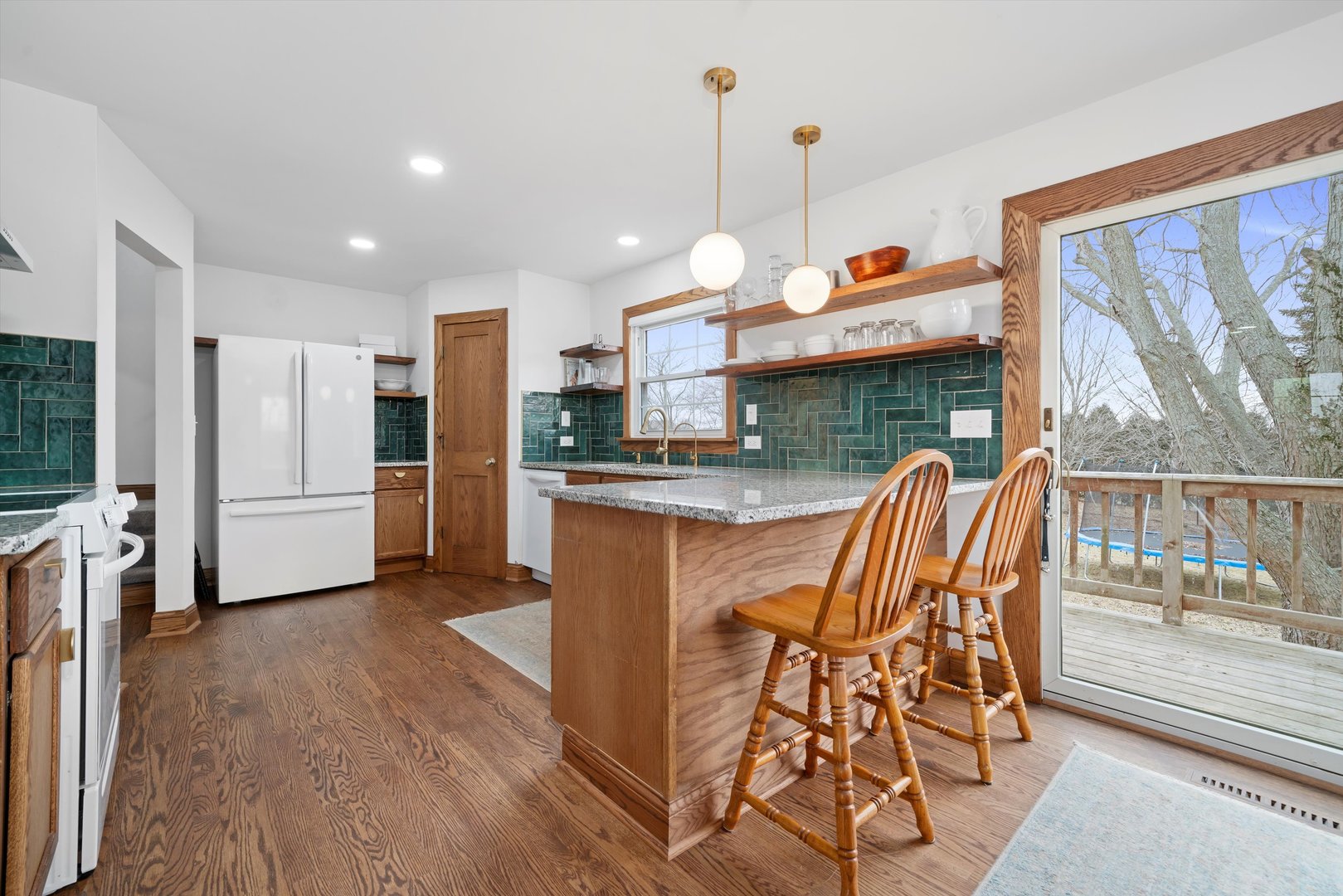 21204 South Pfeiffer Road Frankfort, IL 60423 - Photo 10 of 45 a kitchen with stainless steel appliances granite countertop a refrigerator a oven a sink a dining table and chairs with wooden floor