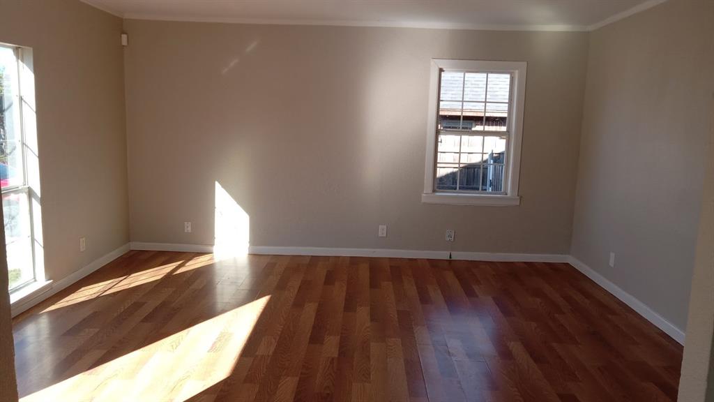 1510 Carson Street Dallas, TX 75216 - Photo 27 of 29 a view of an empty room with wooden floor and a window