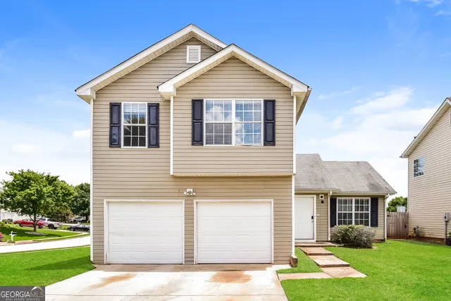 a front view of a house with a yard
