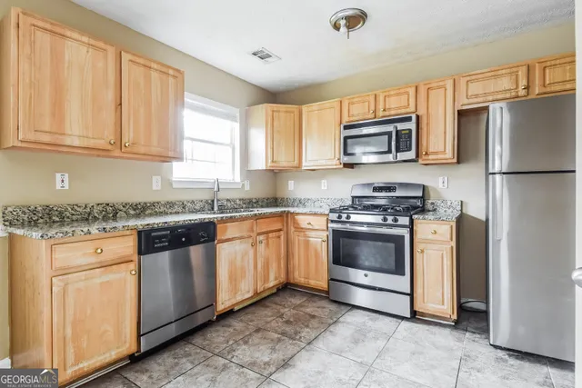 an empty room with a fan & a ceiling fan
