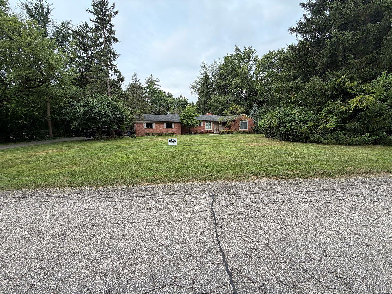3520 Rayburn Road Bloomfield Hills, MI 48304 - Photo 1 of 26 Brick exterior residence with a shingle roof, expansive lawn, and mature trees