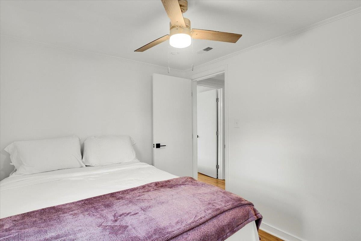 211 North State Street Raleigh, NC 27601 - Photo 14 of 50 a bedroom with a bed and a chandelier