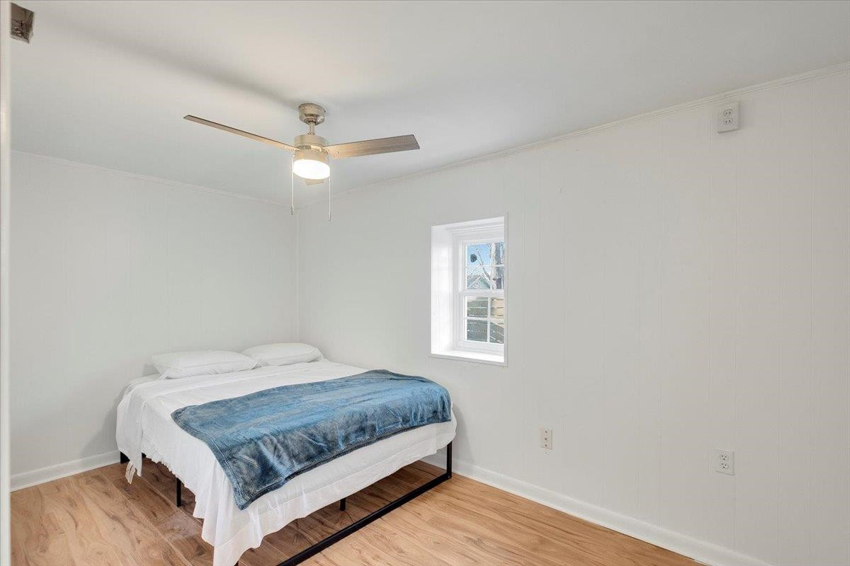 211 North State Street Raleigh, NC 27601 - Photo 16 of 50 a bedroom with a bed dresser and a window