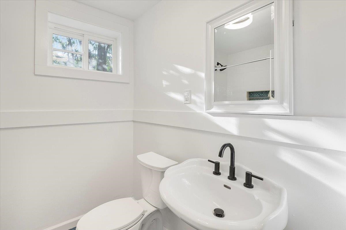 211 North State Street Raleigh, NC 27601 - Photo 19 of 50 a bathroom with a toilet sink and mirror