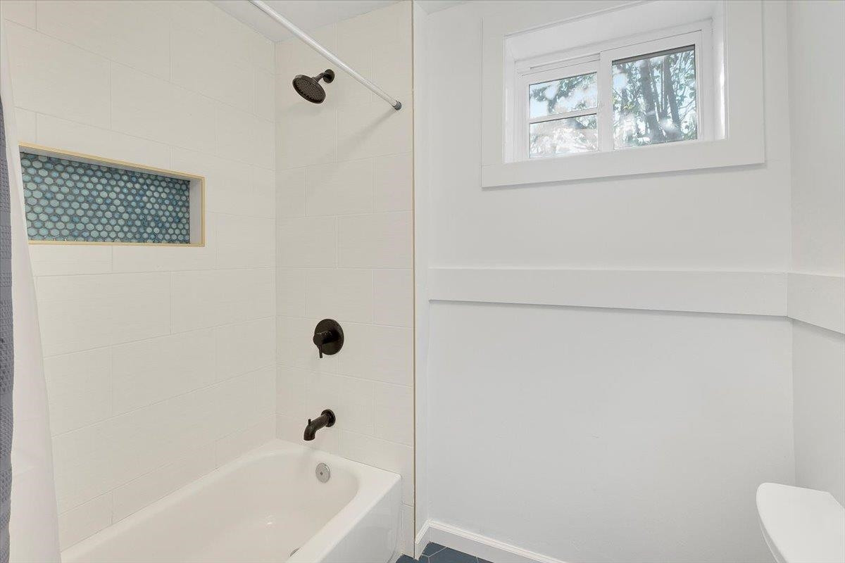 211 North State Street Raleigh, NC 27601 - Photo 20 of 50 a bathroom with a bathtub and a shower