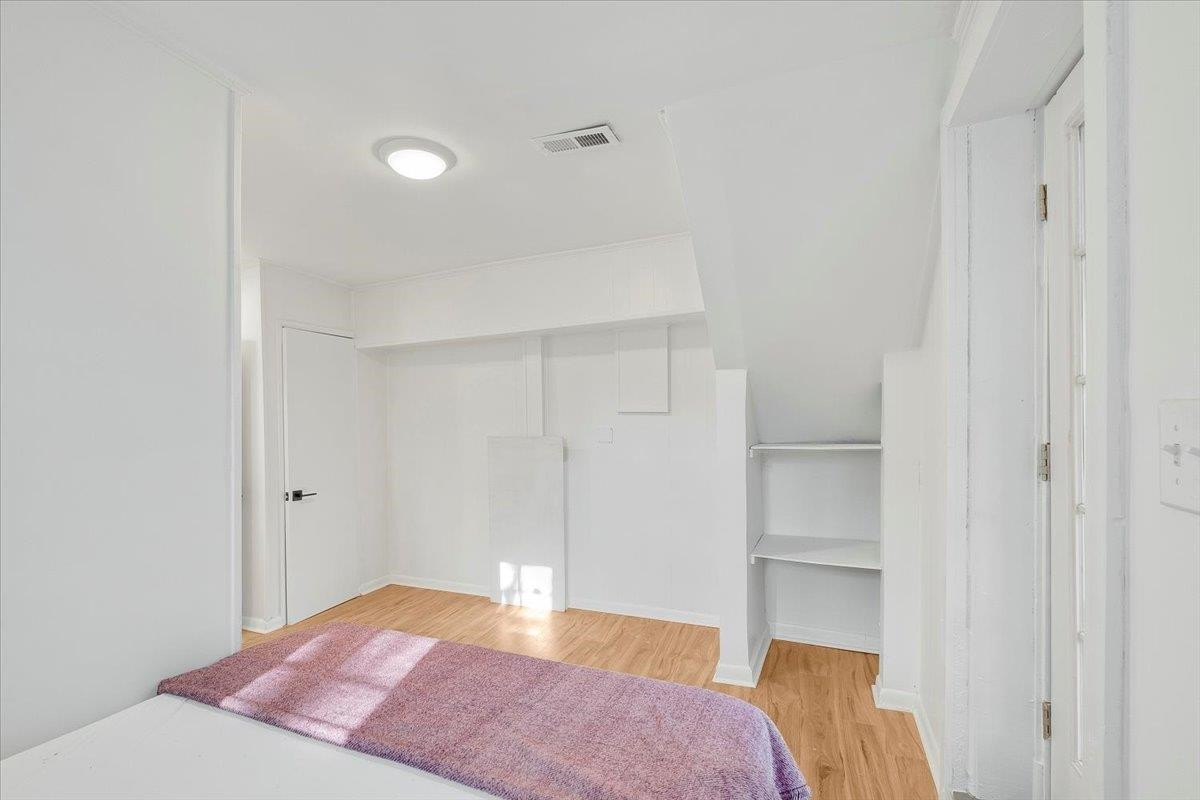 211 North State Street Raleigh, NC 27601 - Photo 22 of 50 a bedroom with a bed and a closet