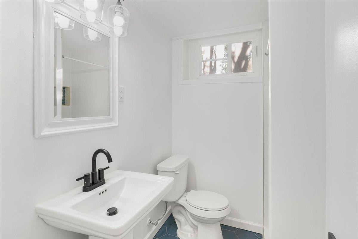 211 North State Street Raleigh, NC 27601 - Photo 23 of 50 a bathroom with a sink mirror and toilet
