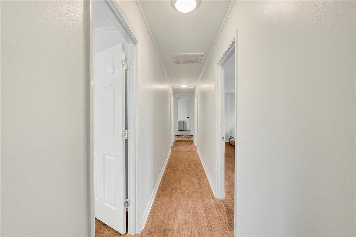 211 North State Street Raleigh, NC 27601 - Photo 28 of 50 a view of a hallway with wooden floor and a bathroom