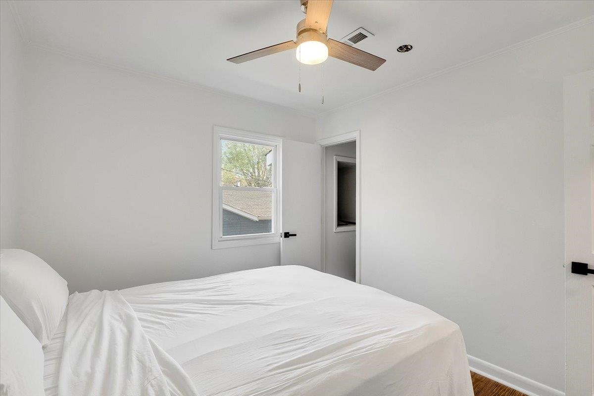 211 North State Street Raleigh, NC 27601 - Photo 38 of 50 a bedroom with a bed and a chandelier