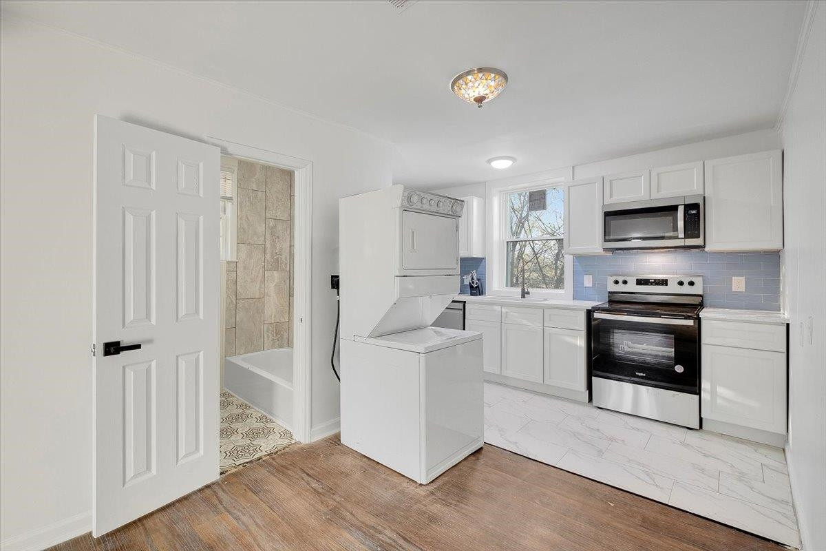 211 North State Street Raleigh, NC 27601 - Photo 41 of 50 a kitchen with white cabinets and stainless steel appliances