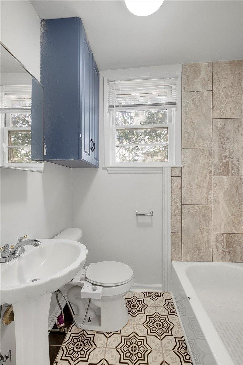 211 North State Street Raleigh, NC 27601 - Photo 44 of 50 a bathroom with a sink a toilet and shower