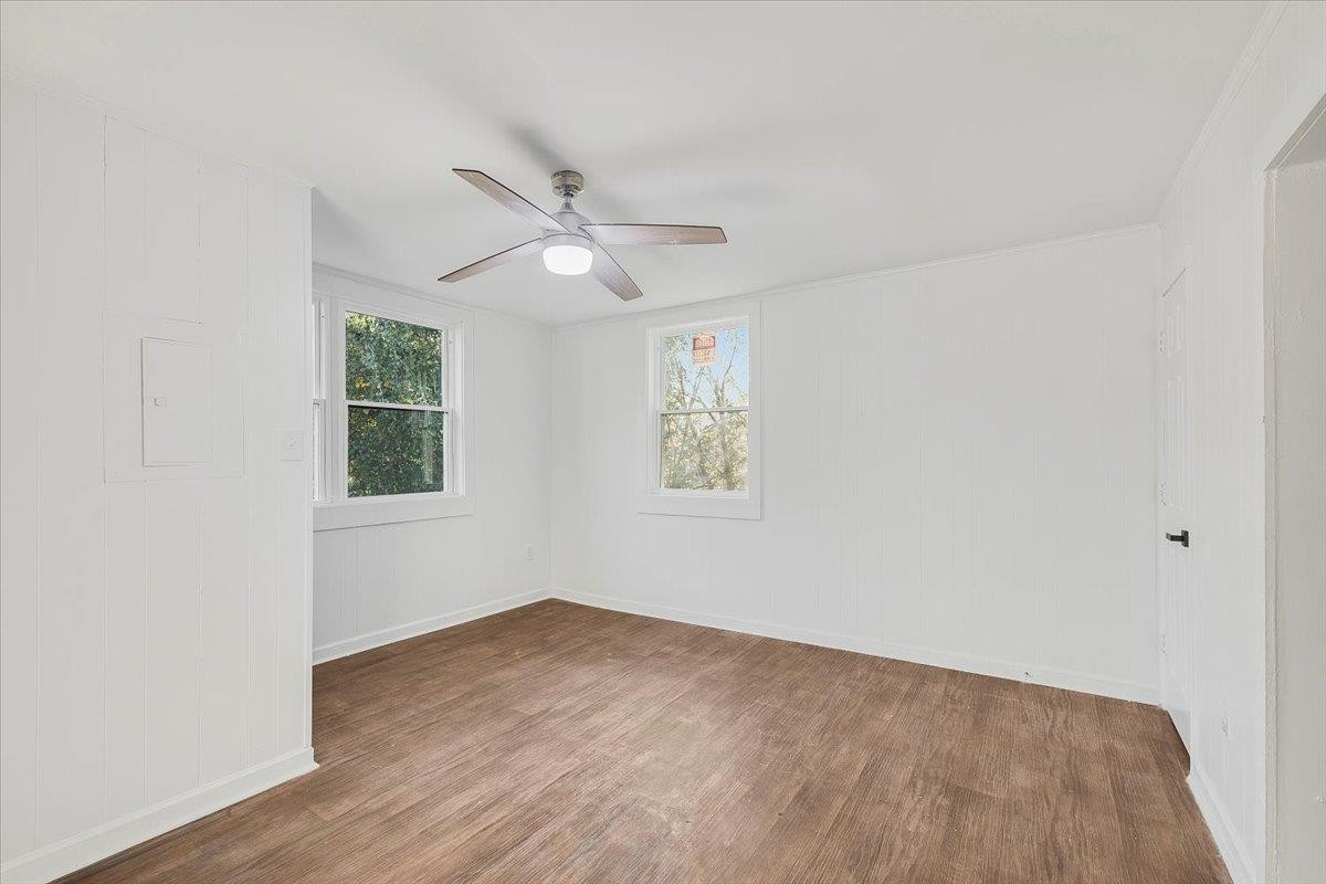 211 North State Street Raleigh, NC 27601 - Photo 47 of 50 an empty room with wooden floor ceiling fan and windows