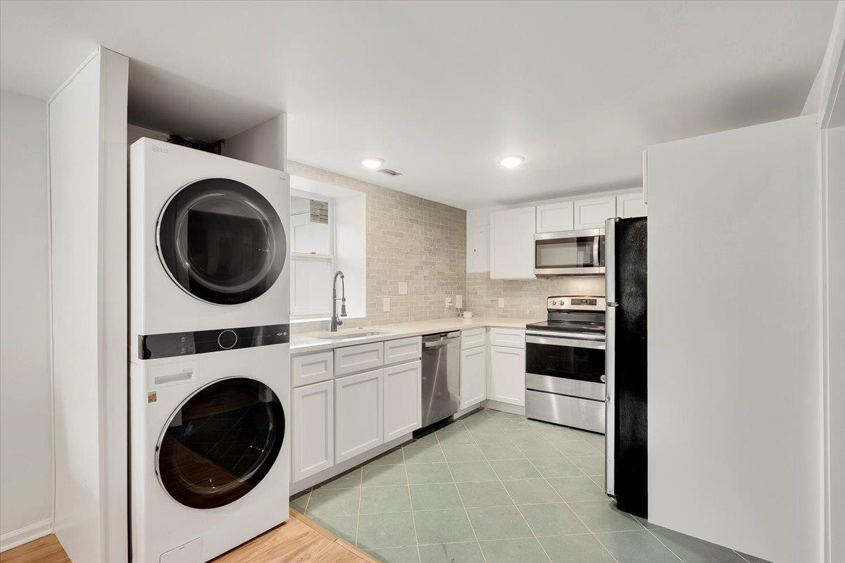 211 North State Street Raleigh, NC 27601 - Photo 7 of 50 a kitchen with a stove top oven and washing machine