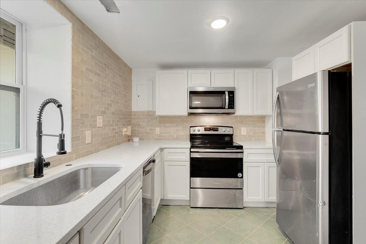 211 North State Street Raleigh, NC 27601 - Photo 9 of 50 a kitchen with a sink a refrigerator and a sink