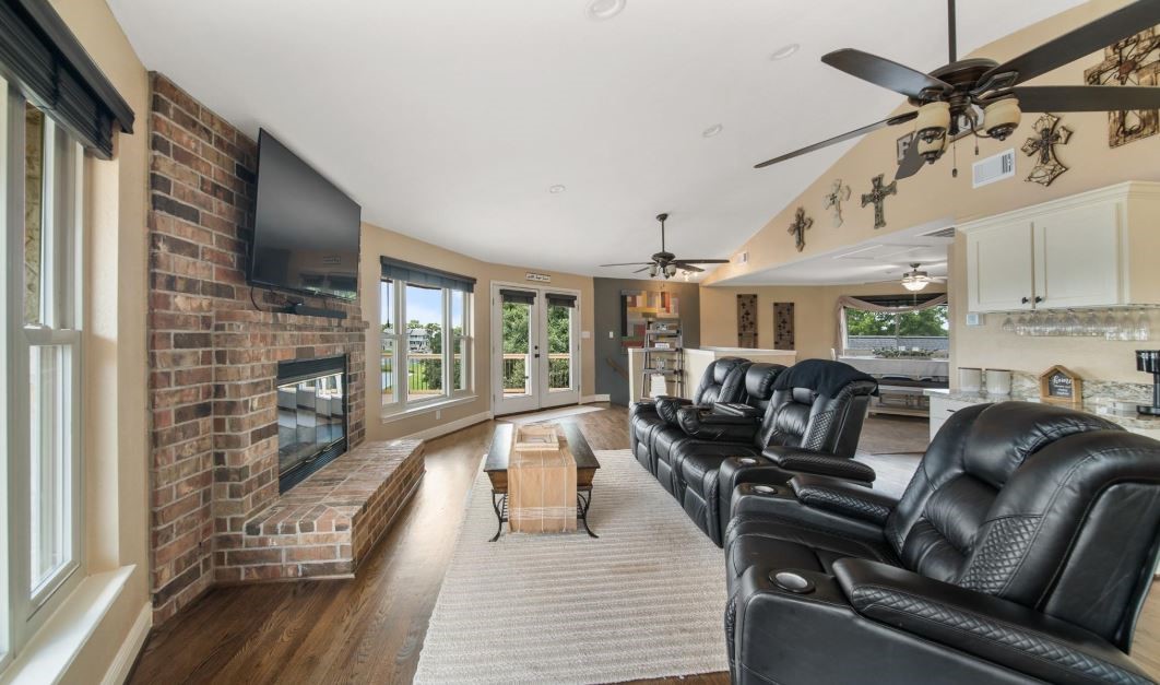 6714 Spray Lane, Unit C699A Rosharon, TX 77583 - Photo 25 of 48 Family Room has a Cozy, Gas Fireplace with Brick Surround. There is a High Ceiling with 2 Ceiling Fans for a Cool Breeze. Whatever Season, this Room will make sure you're comfortable.