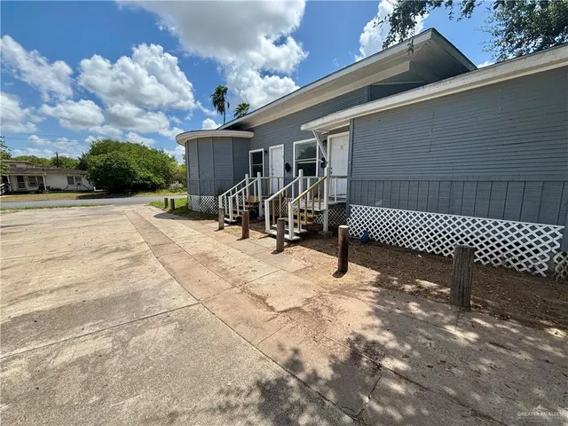 a view of a patio with a table and chairs