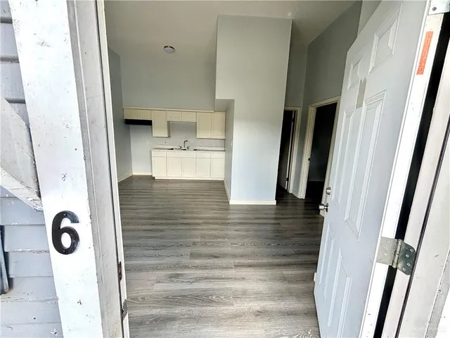 a view of kitchen and hall with wooden floor