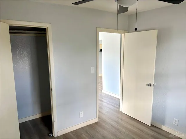 a view of a hallway with wooden floor