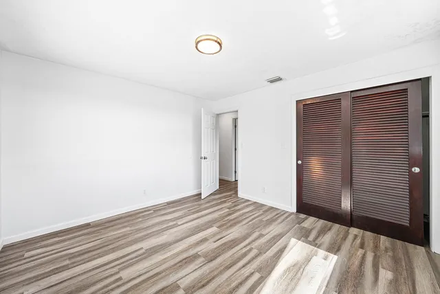 a view of a room with wooden floor