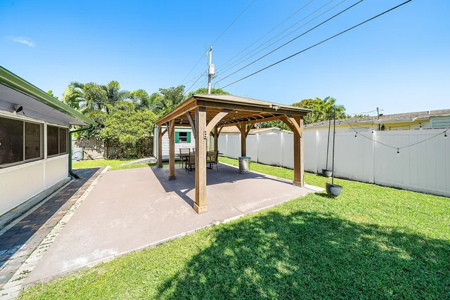 a view of a house with backyard sitting area and garden