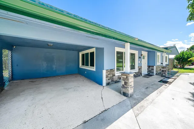 a view of a house with backyard porch and sitting area