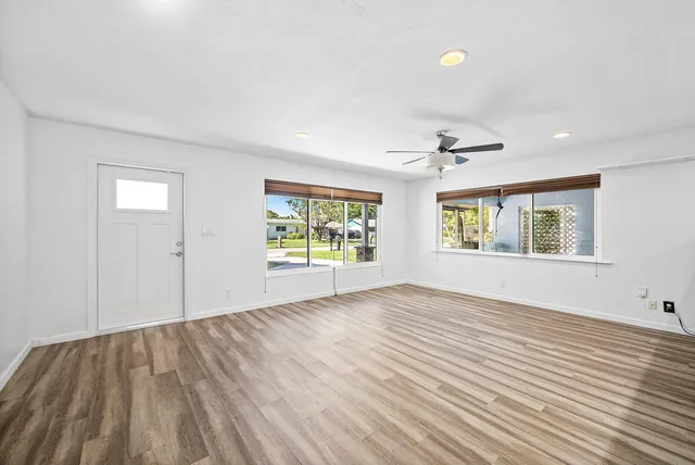 wooden floor in an empty room with a window